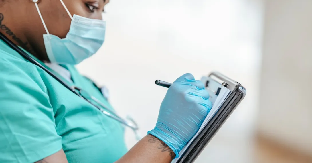 A doctor manually taking notes