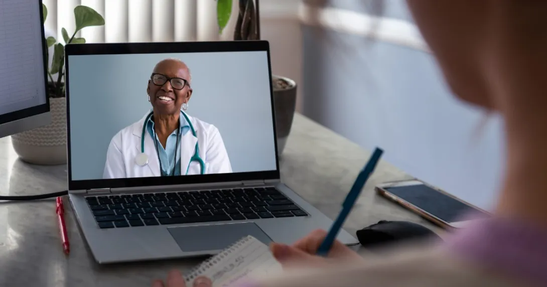 A doctor consults with a patient via video A doctor consults with a patient via video