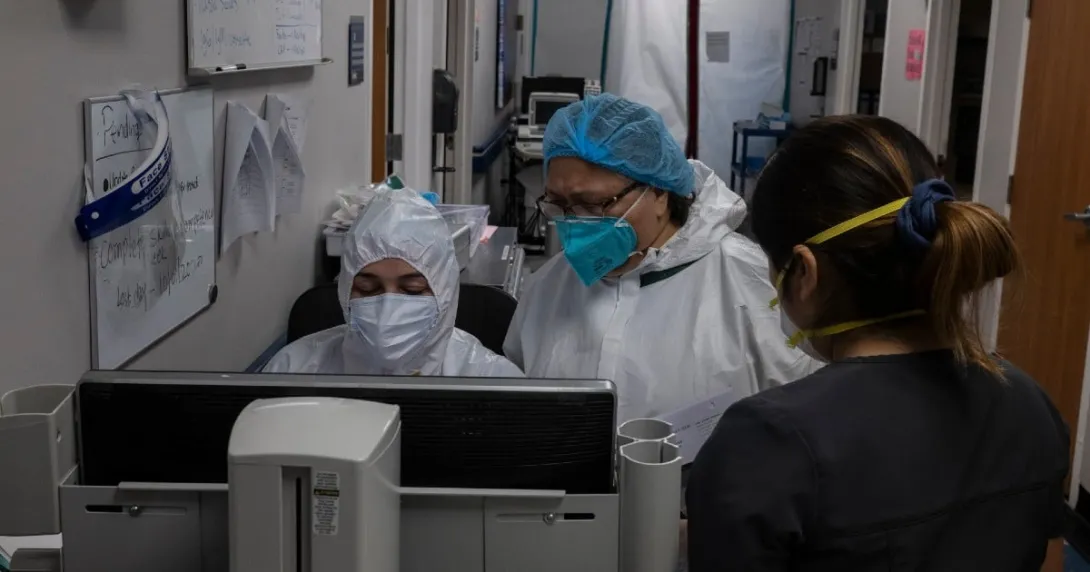 Doctors gather at a computer