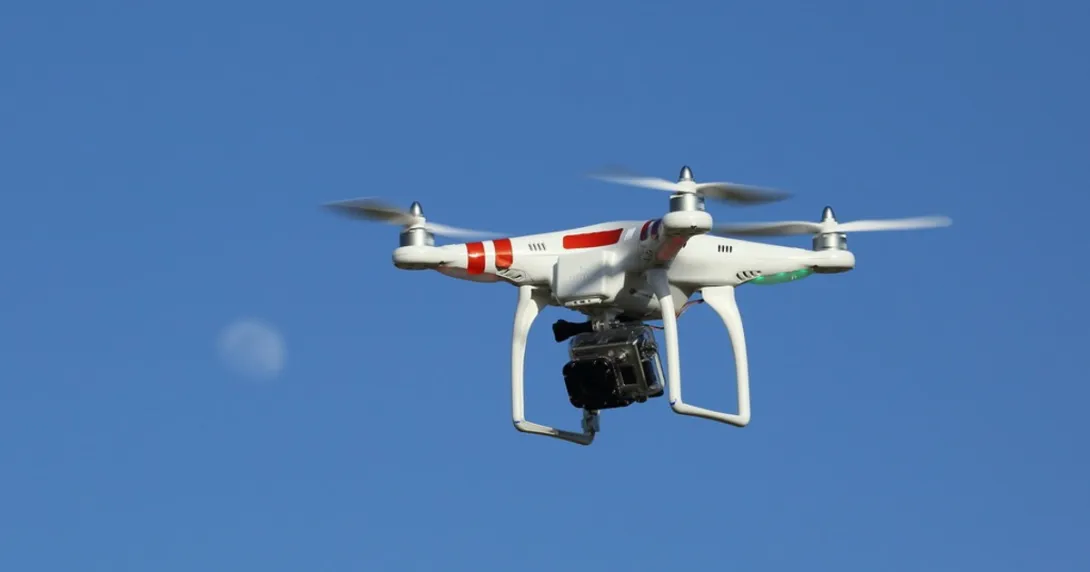 A drone in the sky against a moon