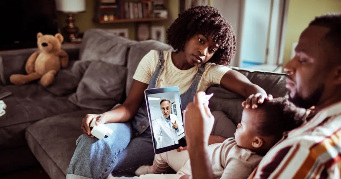 A family consults with a doctor via tablet