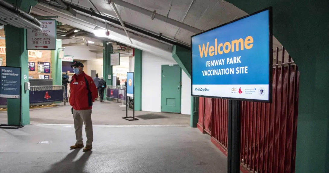 A sign in a corridor saying: Welcome. Fenway Park vaccination site