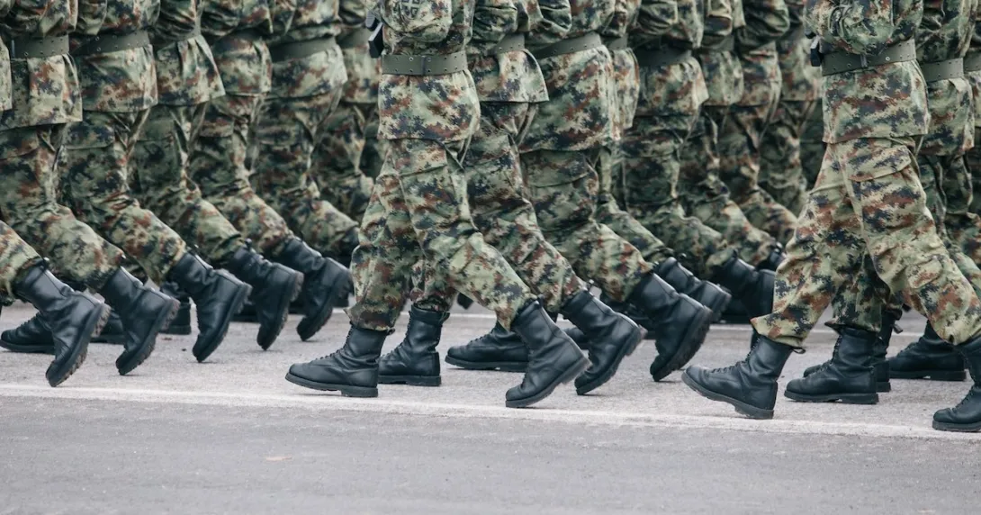 Soldiers in army camouflage walking in formation Soldiers in army camouflage walking in formation