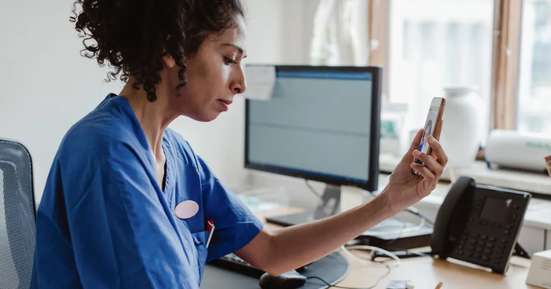 Clinician uses generative AI Clinician with smartphone and at computer using generative AI