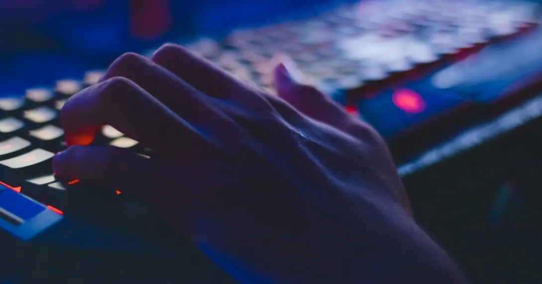 hand on a keyboard in the dark hand on a keyboard in the dark