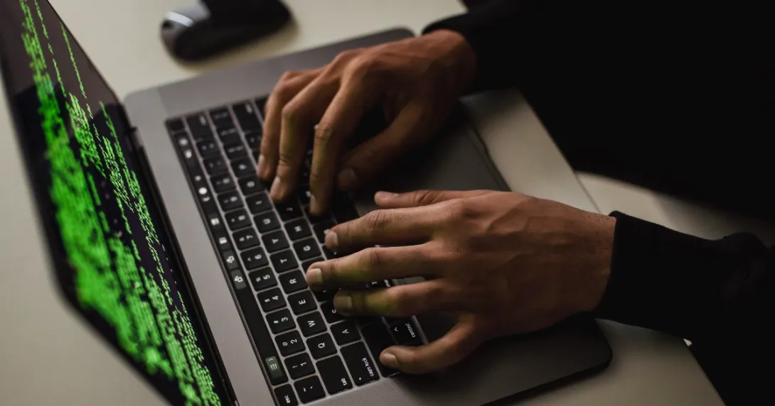 A hacker's hands on a keyboard