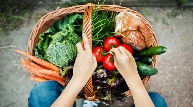 Basket of fresh vegetables and bread