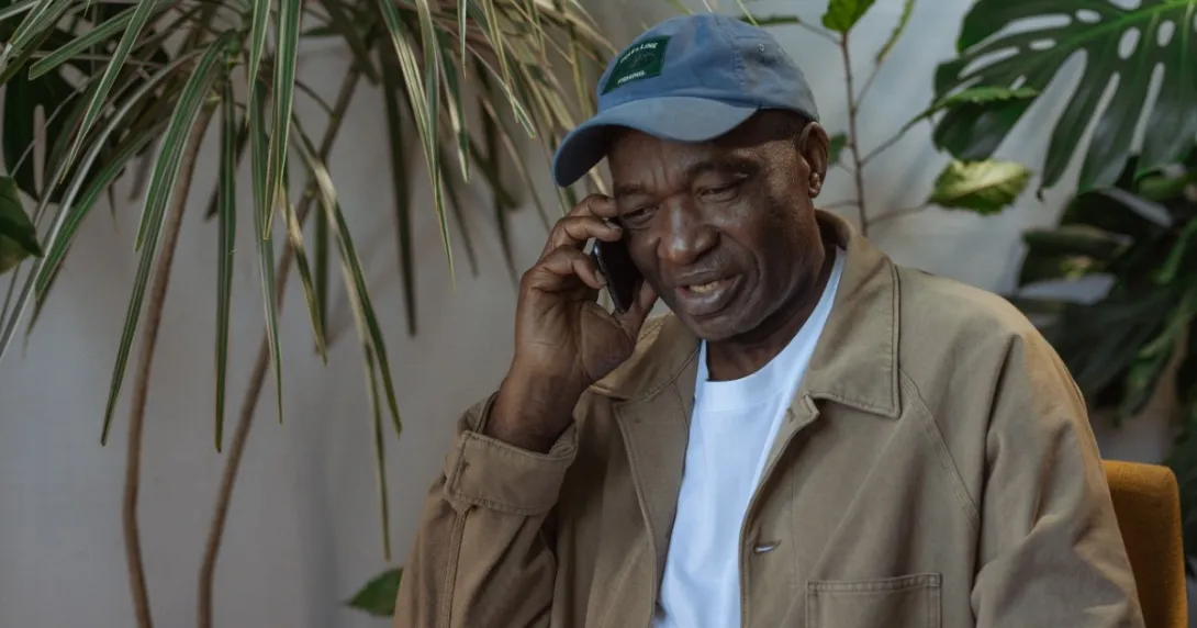 A senior patient talking on a cell phone