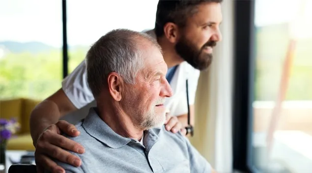 Two people looking out a window