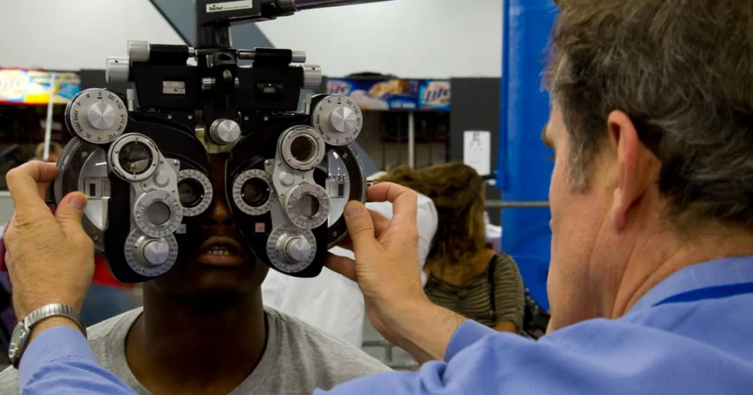An optometrist examines a patient