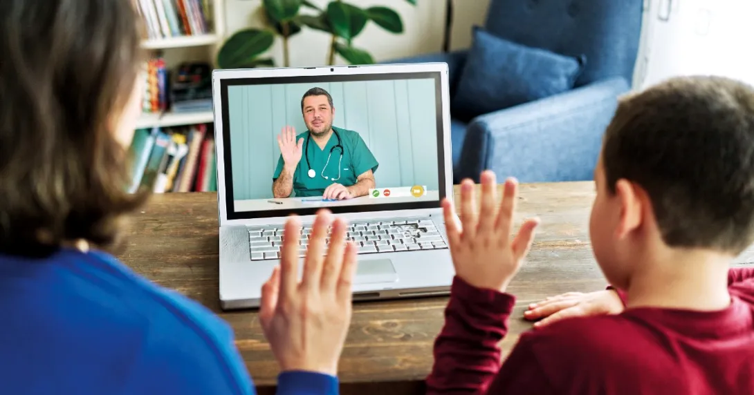 A parent and child wave to a provider via video chat