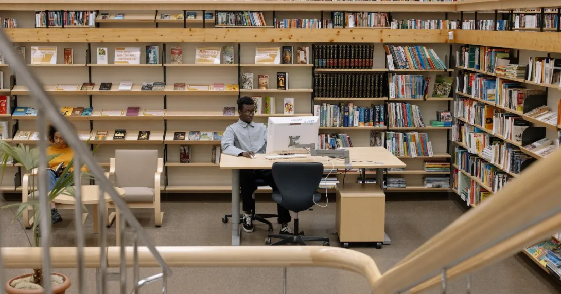 A person on the computer at the library