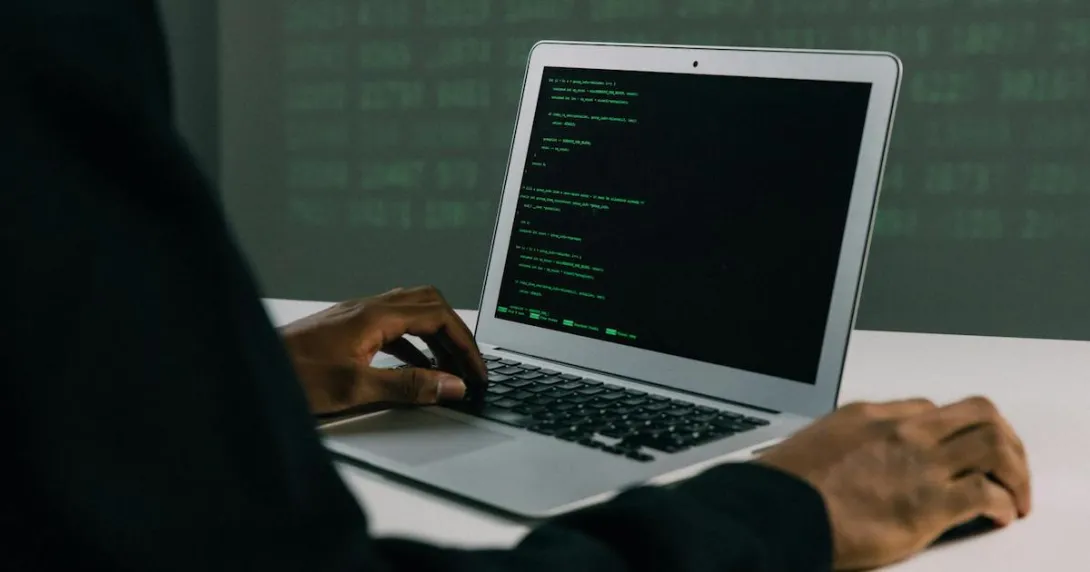 A hacker using a laptop A hacker using a laptop