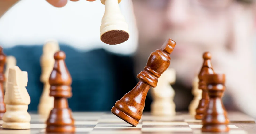 One chess piece knocking over another