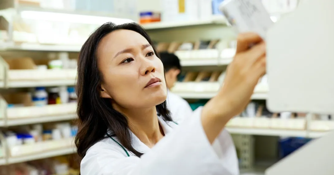 A pharmacist reaches for a drug