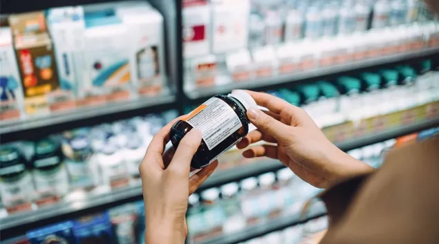 Person looking at pill bottle in Pharmacy
