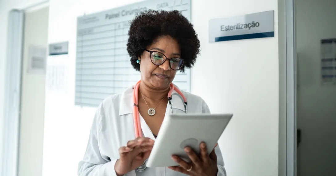 A provider looks at patient forms on a tablet
