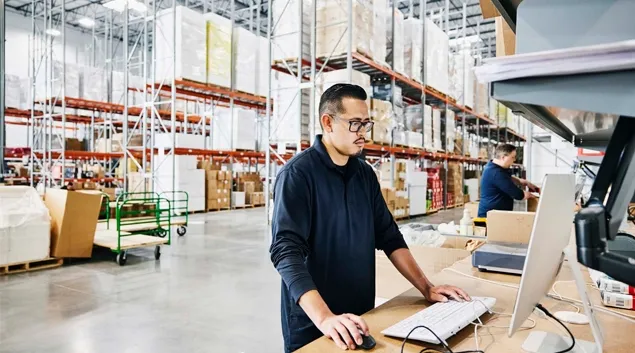 Workers in a warehouse on computers