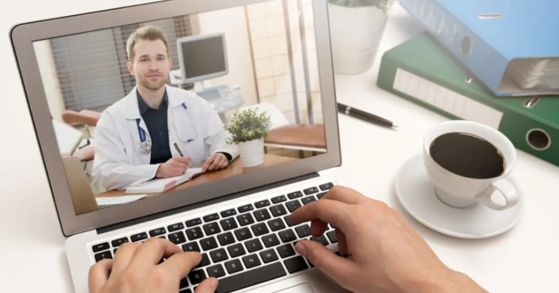 A doctor in a white coat on a computer screen
