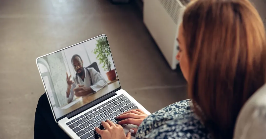 Person attending telehealth appointment on a laptop