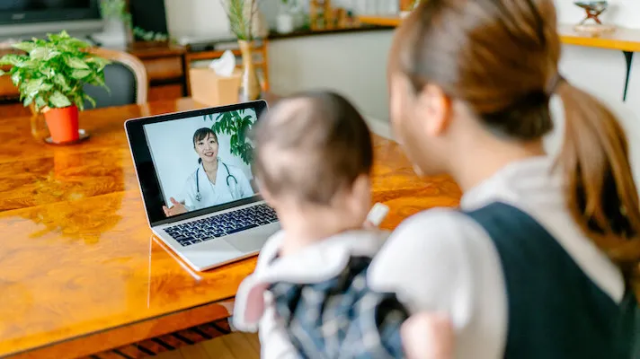 Patient with child attending telehealth appointment