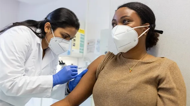 clinician giving patient a shot