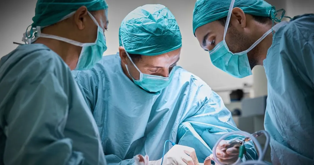 Surgeon and medical team performing surgery Surgeon and medical team performing surgery