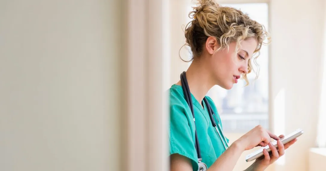 A nurse holding a digital tablet to check a patient's file A nurse holding a digital tablet to check a patient's file