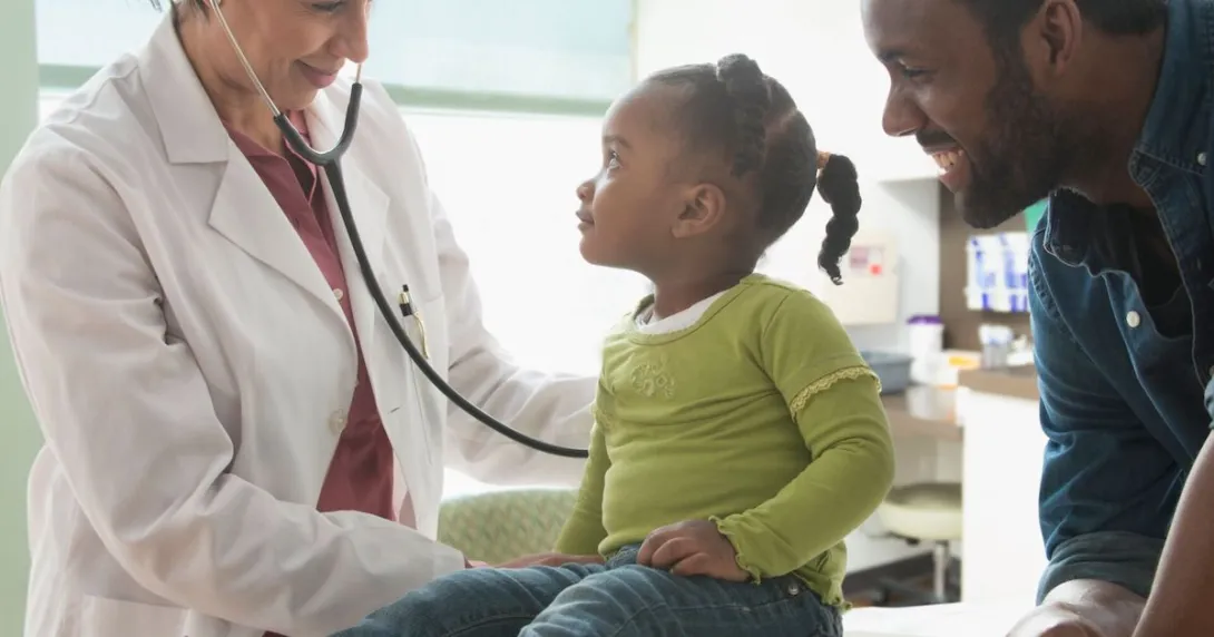 Doctor treating child with parent present