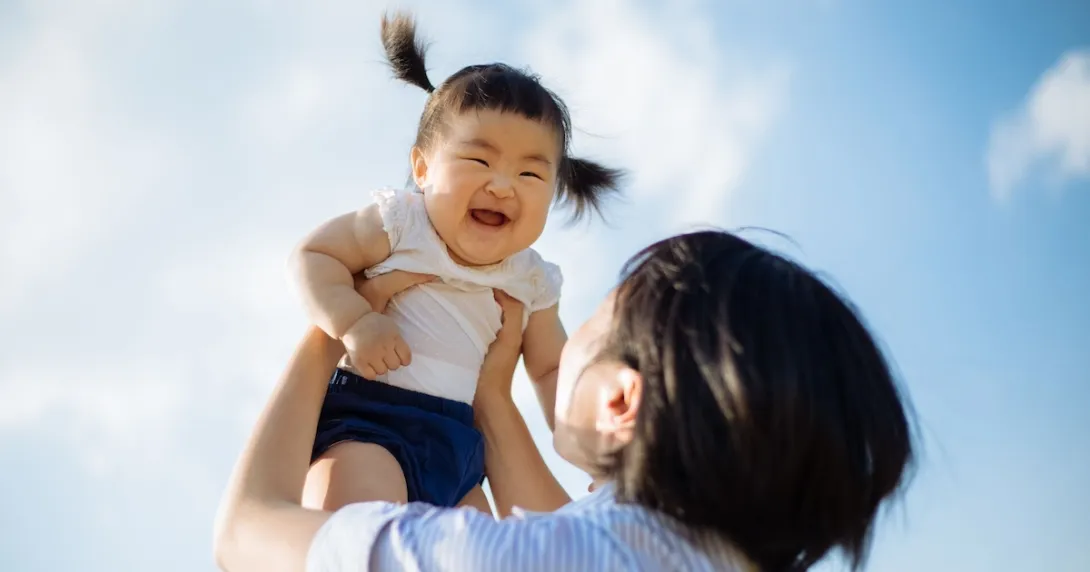 Parent holding child in the air