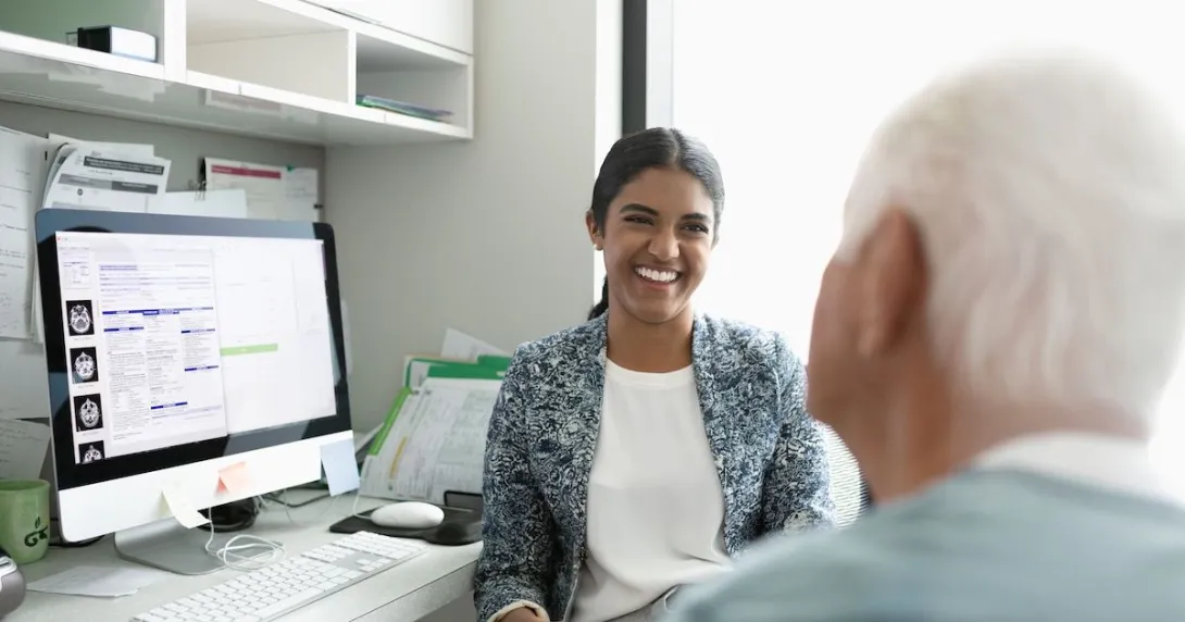 A smiling doctor facing a patient in a consultation A smiling doctor facing a patient in a consultation