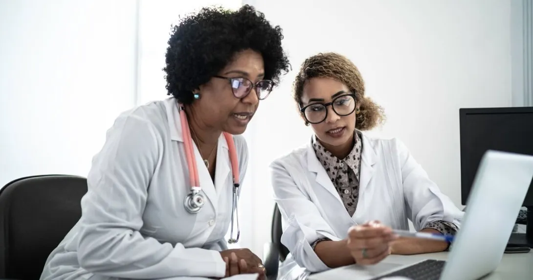 Doctors using a laptop to join a digital conference