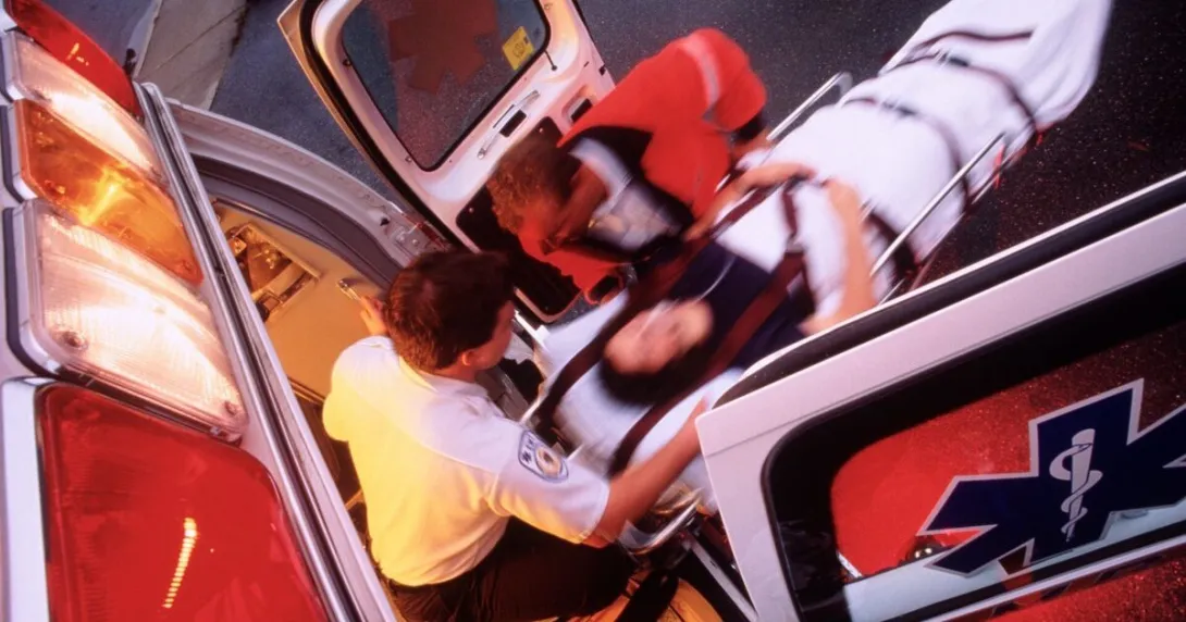 An emergency patient being taken into an ambulance