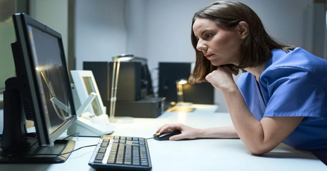 A medical professional looking at a computer screen