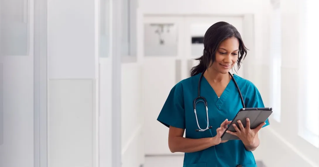 A doctor checking a patient record on their digital tablet. A doctor checking a patient record on their digital tablet.