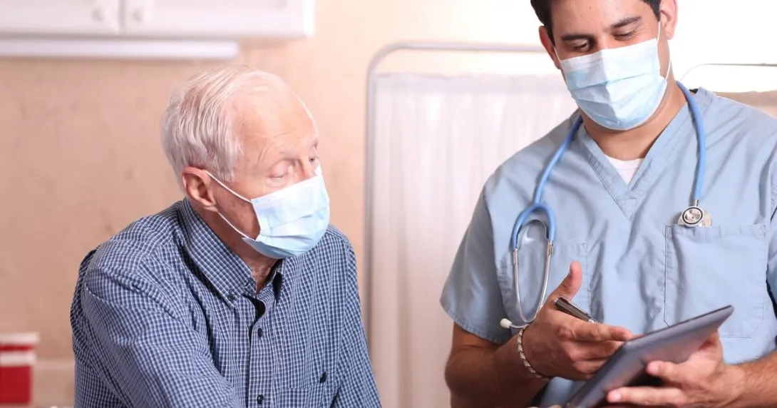 A doctor discussing to an elderly patient their test results using a tablet