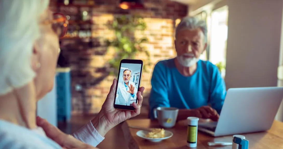 A senior couple consulting with their doctor on their mobile phone