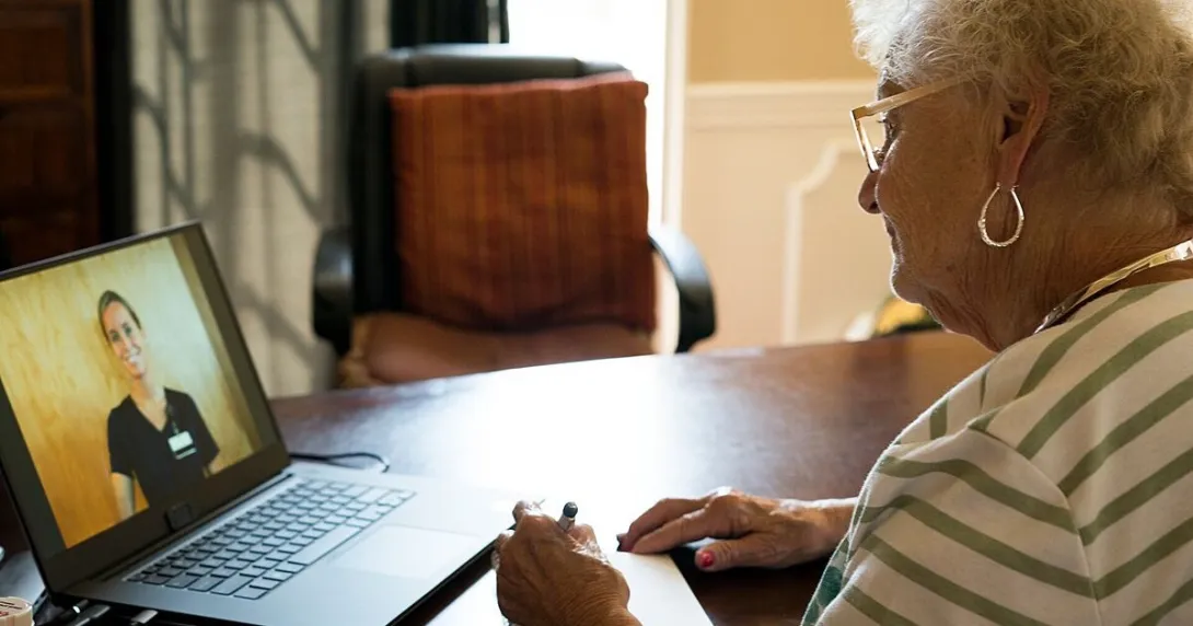 An elderly person in a online consultation with a doctor over laptop