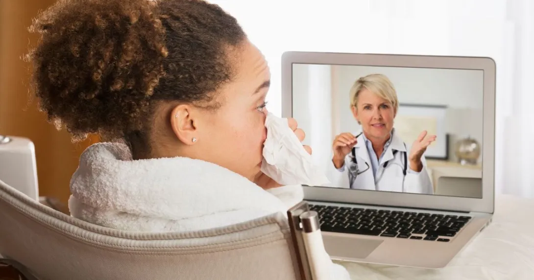 A sick patient in a video consultation with a doctor