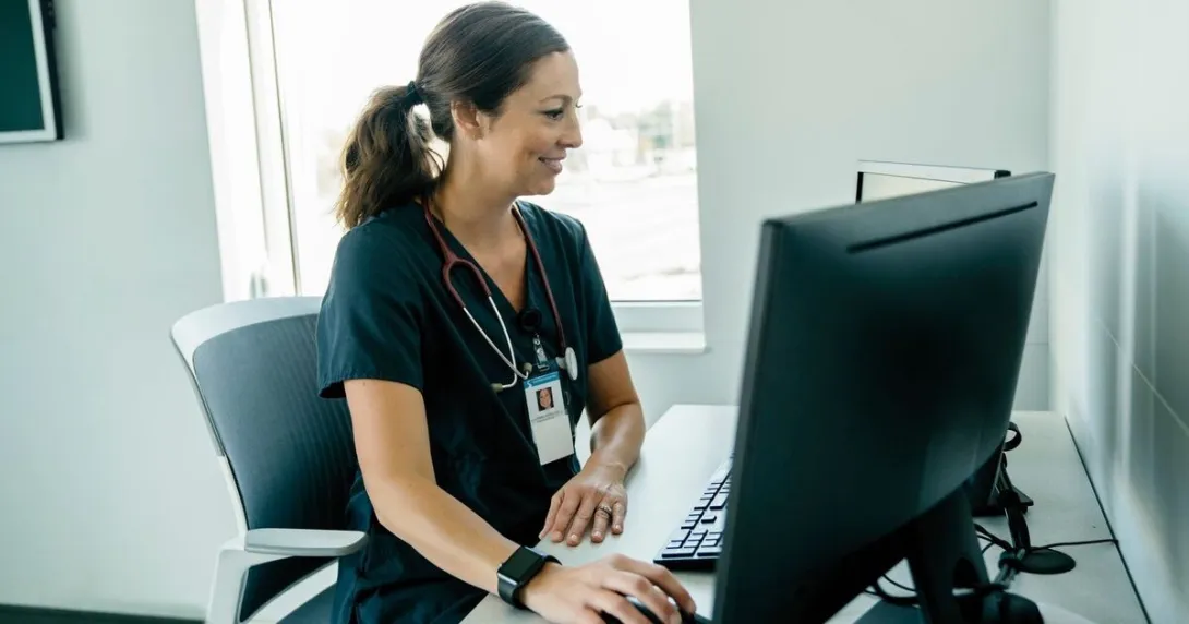 A clinician using a desktop computer