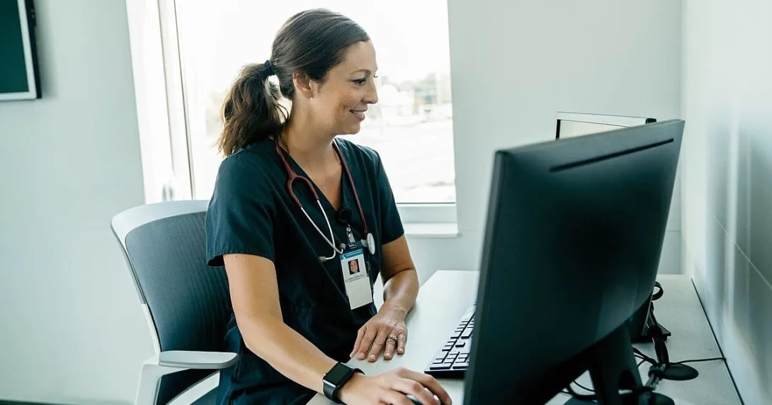 A medical professional using a desktop computer A medical professional using a desktop computer