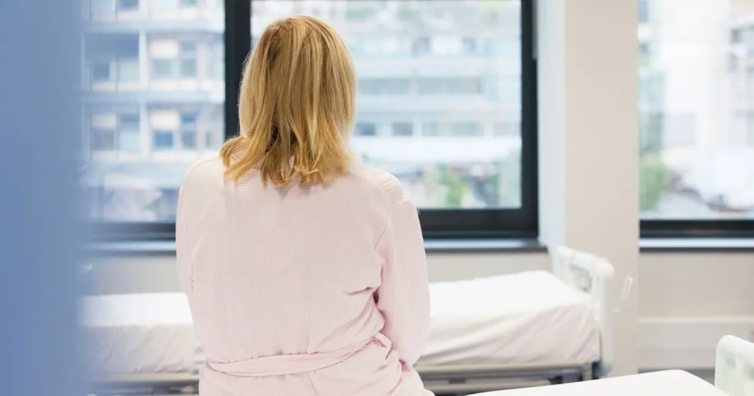 Person sitting on hospital bed