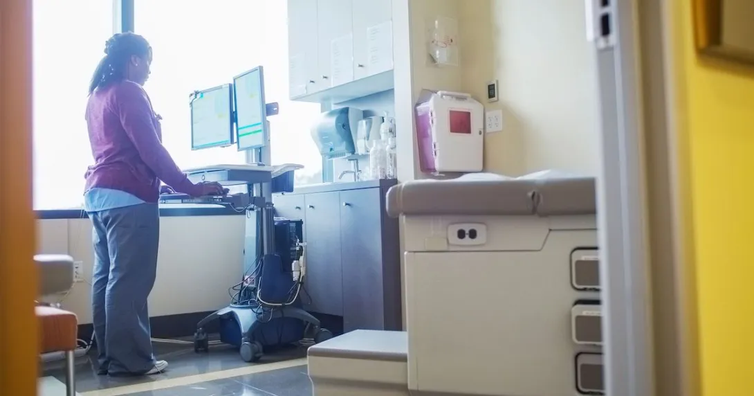 A nurse looking up a patient's record A nurse looking up a patient's record