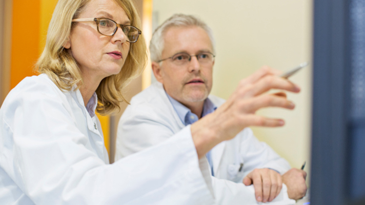 Doctors looking at a monitor.