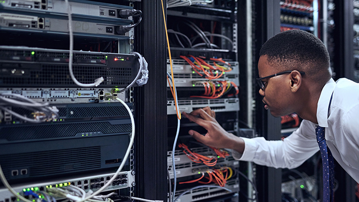 Worker in server room.