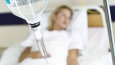 Patient lying in hospital bed with IV drip