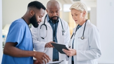 Group of healthcare workers looking at a tablet