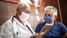 A doctor speaks with a caregiver