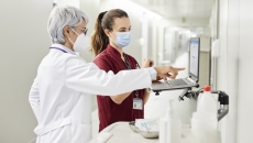 Doctor and nurse look at data on a hospital computer
