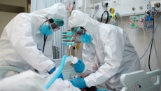 Healthcare workers intubate a patient